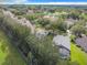 Aerial view of a house with a pool in a tree-lined neighborhood at 2377 Paulette Dr, Haines City, FL 33844