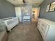 Bedroom with crib, changing table, and dresser at 2346 Upland Ln, Apopka, FL 32712