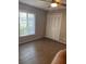 Well-lit bedroom with double door closet and wood-look floors at 102 Oakridge Ct, Sanford, FL 32773