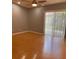 Living room with laminate floor and sliding glass door at 102 Oakridge Ct, Sanford, FL 32773