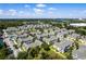 Aerial view of community, showcasing numerous townhouses and a central lake at 4560 Yellowgold E Rd # 101, Kissimmee, FL 34746