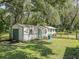 Two detached outbuildings, one appearing larger than the other, sit on a grassy lot at 5311 Shady Oak N Dr, Lakeland, FL 33810