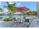 Poolside table with chairs under an umbrella at 1882 Walnut Creek Dr, Kissimmee, FL 34744