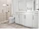 Modern bathroom with white vanity, glass shower, and tile flooring at 3198 Sailing Pier Ave, Winter Garden, FL 34787