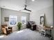Bright home office features a workspace, comfortable armchair, and large windows at 3198 Sailing Pier Ave, Winter Garden, FL 34787