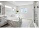 Luxurious bathroom with soaking tub, double vanity, and walk-in shower at 3198 Sailing Pier Ave, Winter Garden, FL 34787
