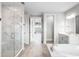 Spa-like bathroom with marble finishes, soaking tub and walk-in shower at 3198 Sailing Pier Ave, Winter Garden, FL 34787