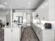 Modern kitchen with white cabinets, quartz countertops and stainless steel appliances at 3198 Sailing Pier Ave, Winter Garden, FL 34787
