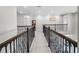 Elegant hallway with ornate railings and neutral carpeting at 3198 Sailing Pier Ave, Winter Garden, FL 34787