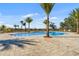 Community pool with palm trees and plenty of lounge space at 3198 Sailing Pier Ave, Winter Garden, FL 34787