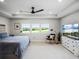 Bright and airy main bedroom with large windows and a sitting area at 3198 Sailing Pier Ave, Winter Garden, FL 34787