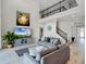 Bright living room with high ceilings, hardwood floors, and modern furniture at 3198 Sailing Pier Ave, Winter Garden, FL 34787