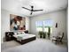 Main bedroom with large window, ceiling fan, and stylish decor at 3198 Sailing Pier Ave, Winter Garden, FL 34787