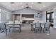 Community room with tables, chairs, and a large screen TV at 3198 Sailing Pier Ave, Winter Garden, FL 34787