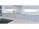 Bright kitchen with white cabinets and stainless steel appliances at 3198 Sailing Pier Ave, Winter Garden, FL 34787