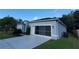 Gray house exterior with a screened garage and well-maintained lawn at 1411 Swift Ct, Kissimmee, FL 34759