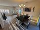 Dining area with dark wood table and light colored chairs at 1411 Swift Ct, Kissimmee, FL 34759