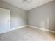 Simple bedroom with tile floors and single door closet at 1628 S Grove St, Eustis, FL 32726