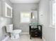 Bathroom with glass vanity and tiled floors at 1628 S Grove St, Eustis, FL 32726