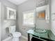Clean bathroom with toilet, sink, and medicine cabinet at 1628 S Grove St, Eustis, FL 32726