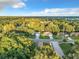 Aerial view of a residential neighborhood showcasing tree-lined streets and houses at 1628 S Grove St, Eustis, FL 32726