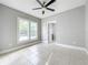 Bedroom with tile floors and double closets at 1628 S Grove St, Eustis, FL 32726