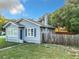 Side view of a blue house with a wooden fence at 1628 S Grove St, Eustis, FL 32726