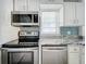 White shaker cabinets, granite countertops, and stainless steel appliances in this kitchen at 1628 S Grove St, Eustis, FL 32726
