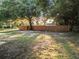 Backyard with fence and mature trees at 1628 S Grove St, Eustis, FL 32726