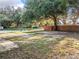 Large backyard with a fence and mature trees at 1628 S Grove St, Eustis, FL 32726