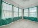 Sunroom with green curtains and tile flooring at 1628 S Grove St, Eustis, FL 32726