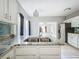 Granite countertop kitchen island with stainless steel sink and open concept to living area at 1628 S Grove St, Eustis, FL 32726