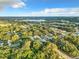 Aerial view of a residential neighborhood showcasing tree-lined streets and houses at 1628 S Grove St, Eustis, FL 32726