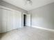 Bedroom with tile floors and closet, near hallway at 1628 S Grove St, Eustis, FL 32726