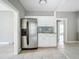 Stainless steel refrigerator in kitchen with white cabinets and granite countertops at 1628 S Grove St, Eustis, FL 32726