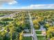 Aerial view of a residential neighborhood showcasing tree-lined streets and houses at 1628 S Grove St, Eustis, FL 32726