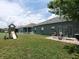 Backyard with playground, patio furniture, and green lawn at 714 Hacienda Cir, Kissimmee, FL 34741