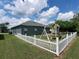 Backyard with white picket fence, playground, and patio at 714 Hacienda Cir, Kissimmee, FL 34741