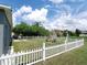 Backyard with white picket fence, playground, and patio furniture at 714 Hacienda Cir, Kissimmee, FL 34741