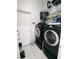 Laundry room with washer, dryer, and storage shelves at 714 Hacienda Cir, Kissimmee, FL 34741