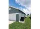 Gray house with white garage door, and green lawn at 714 Hacienda Cir, Kissimmee, FL 34741