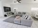 Living room with sectional sofa and large TV at 714 Hacienda Cir, Kissimmee, FL 34741