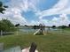 Large backyard with playground set and lake view at 714 Hacienda Cir, Kissimmee, FL 34741