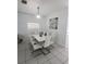 Modern dining room with white table and chairs at 714 Hacienda Cir, Kissimmee, FL 34741