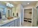 Double vanity bathroom with granite countertop and walk-in closet at 1687 Kona Ln, Davenport, FL 33897