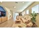 Spacious living room with large sectional sofa and wood floors at 1687 Kona Ln, Davenport, FL 33897