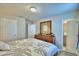 Bright bedroom with a queen bed, dresser, and ensuite bathroom access at 1687 Kona Ln, Davenport, FL 33897