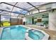 Spacious pool and spa with a screened-in patio and seating area at 1687 Kona Ln, Davenport, FL 33897