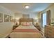 Bright bedroom with king bed, and ensuite bath access at 1687 Kona Ln, Davenport, FL 33897