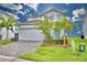 Two-story house with gray-blue door and paver driveway at 1687 Kona Ln, Davenport, FL 33897